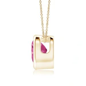 Side view of heart-cut lab pink sapphire pendant in yellow gold