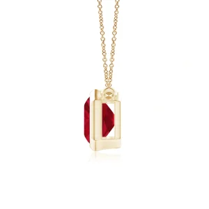 Side view of ruby pendant in yellow gold bezel setting